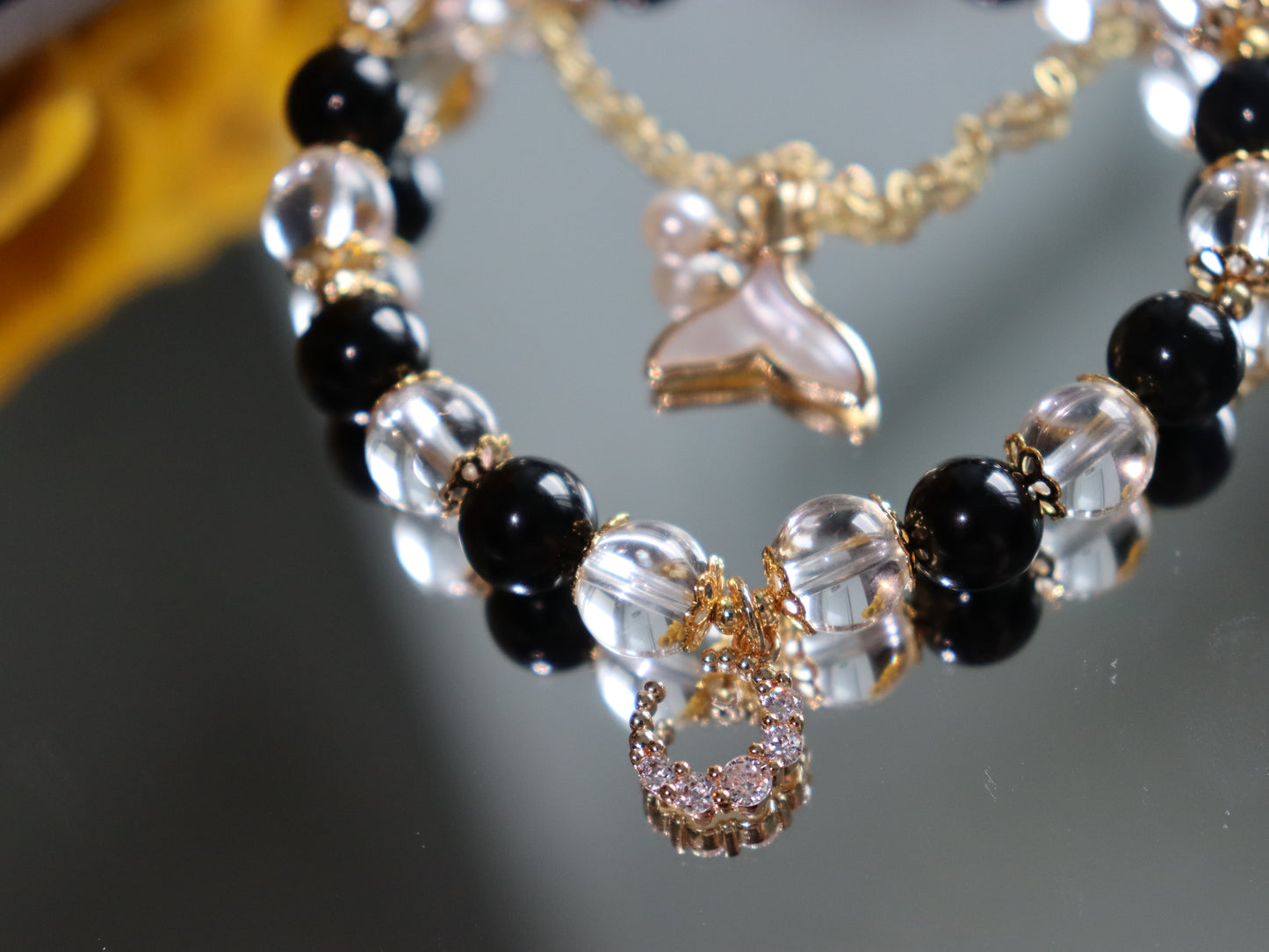 Elegant Obsidian & Rock Crystal Bracelet with 18K Gold Mother-of-Pearl Fish Tail and Moonstone Charm